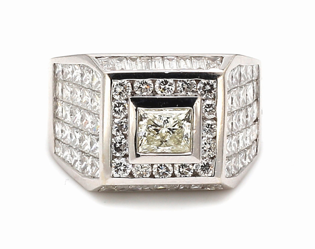 Ring w/ 5x5 invisible set princess cuts, channel set baguettes, rounds around bezel set princess cut center stone.  D6.71ct.t.w.  (Center - 1.01ct.)