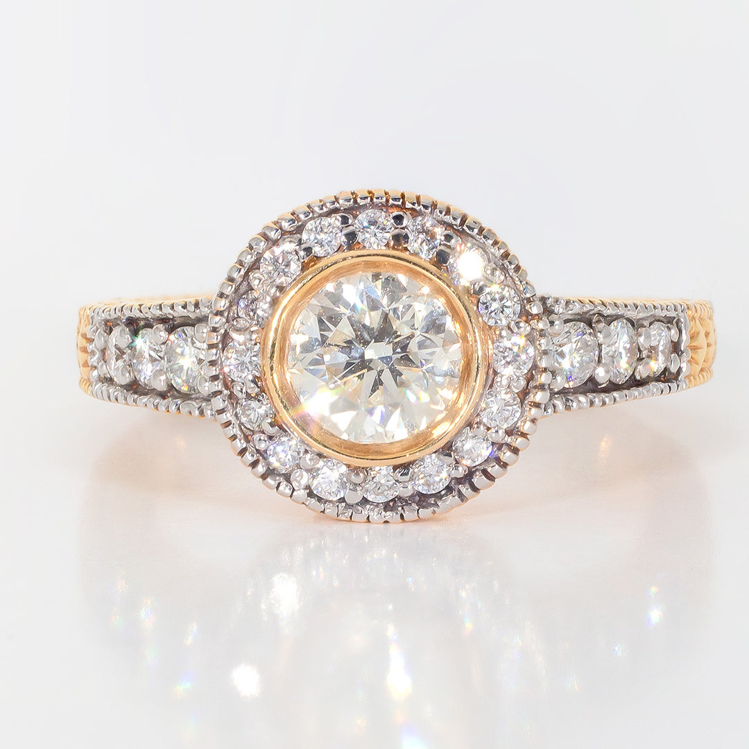 Halo ring in 14K RG with engraving and milligrain on shank, pave set rounds around bezel set round diamond center stone.  D0.94ct.t.w.  (Center 0.59ct.)