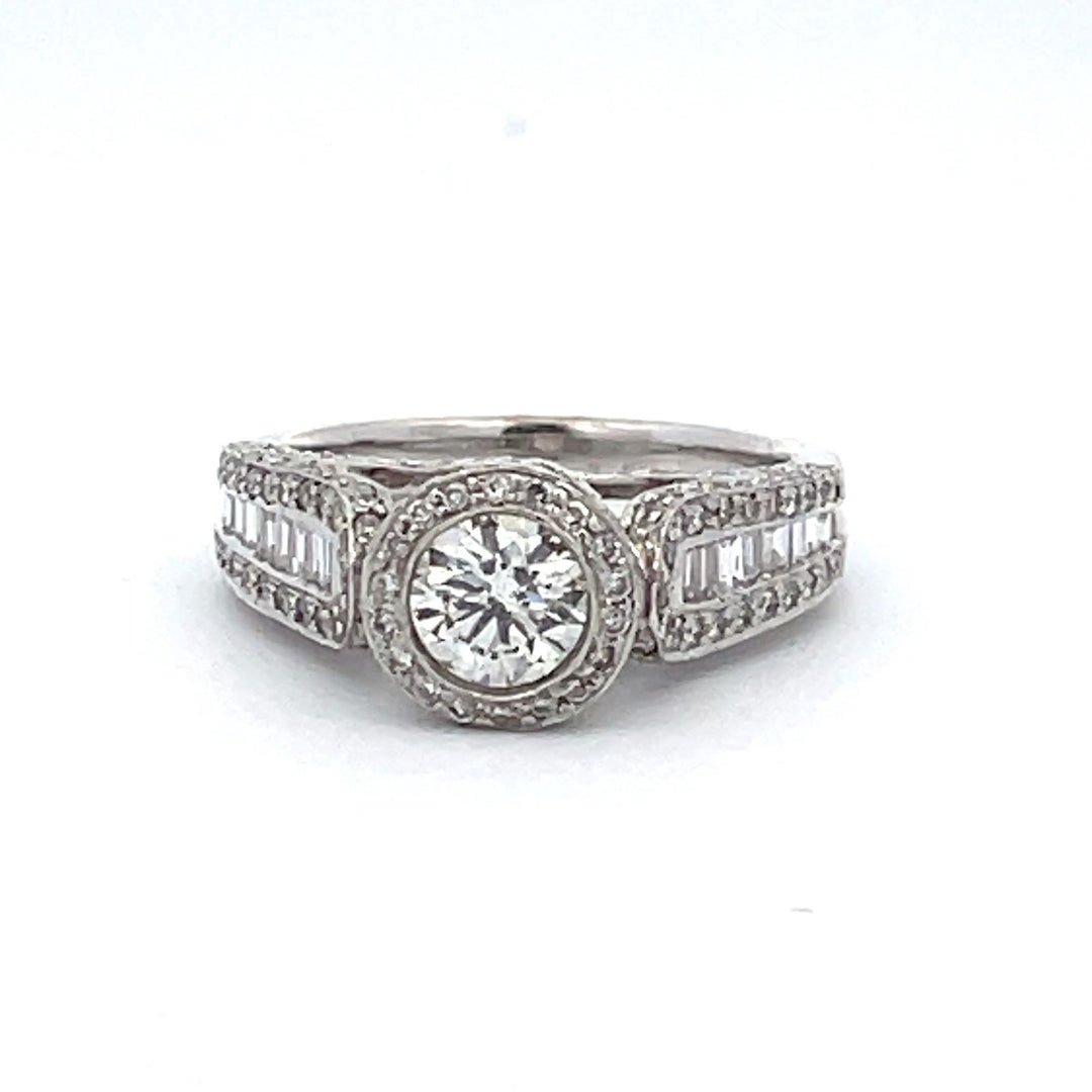 Halo ring with channel set baguettes, pave set rounds, & a bezel set round diamond center.  D1.83ct.t.w.  (Center - 0.63ct.)