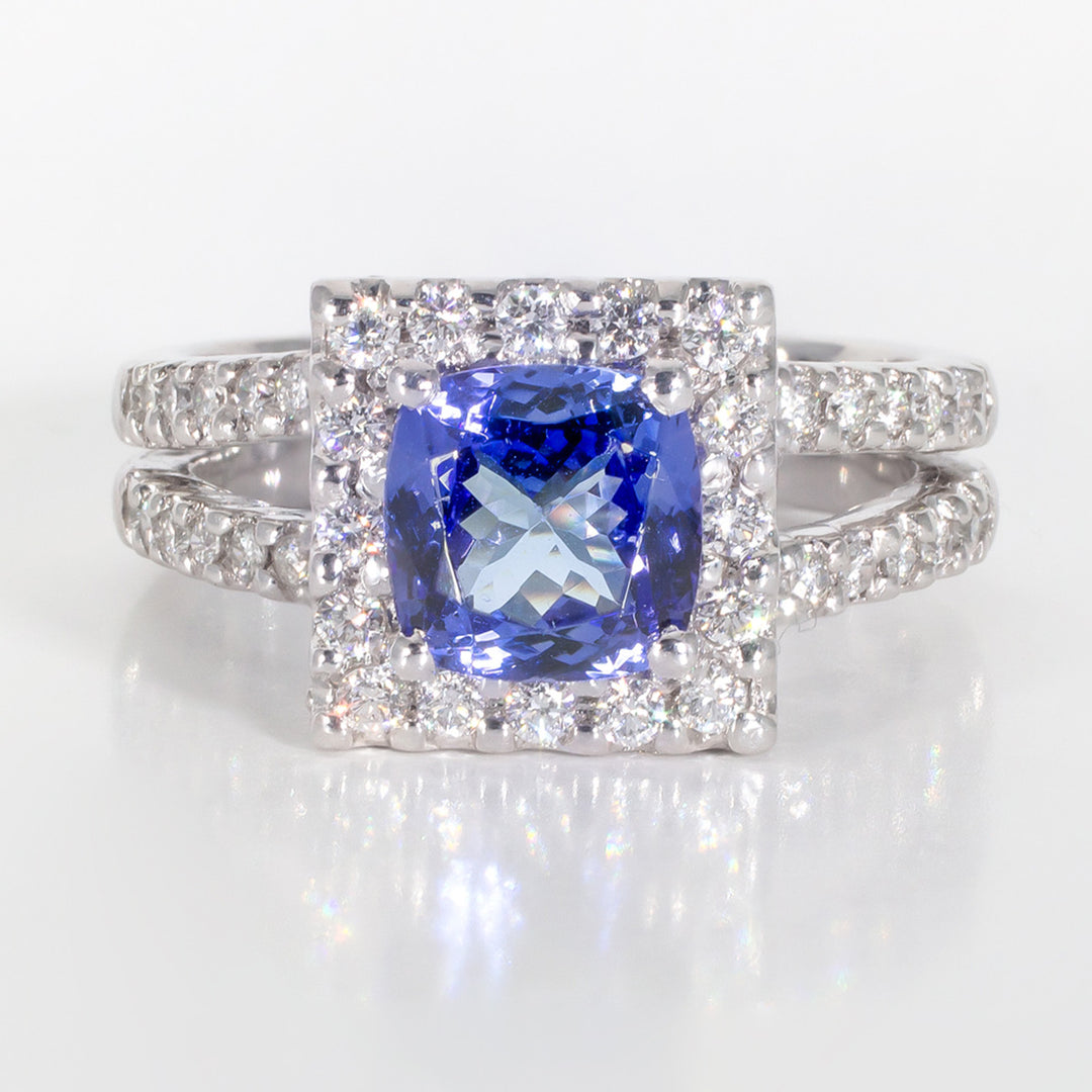 Halo ring in platinum with prong set round diamonds and 4-prong set tanzanite centerstone.  D0.75ct.t.w.  Tanzanite 1.74ct.