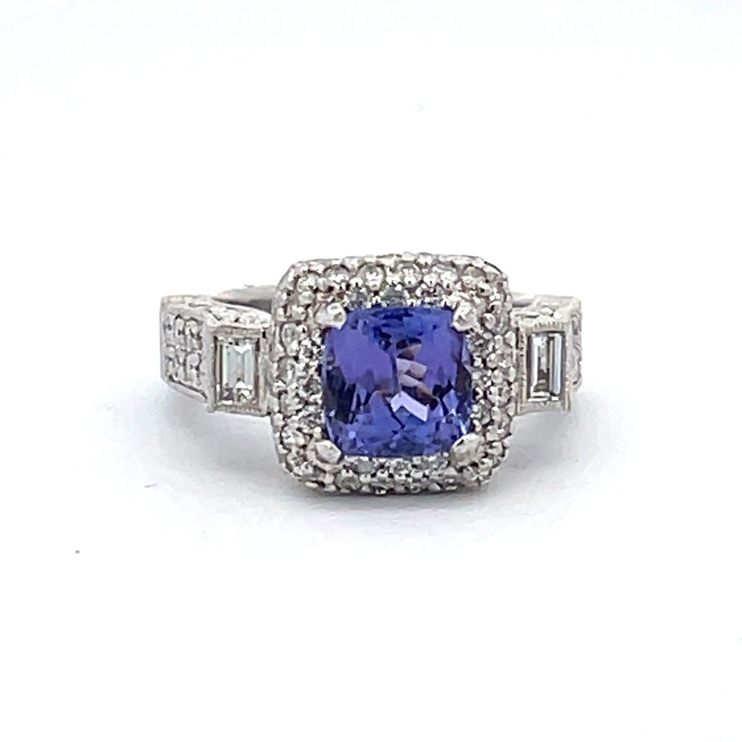 Art-deco style ring in platinum with bezel set baguettes, pave set round diamonds and 4-prong set Tanzanite center.  D1.55ct.t.w.  (Tanzanite - 2.00ct.)