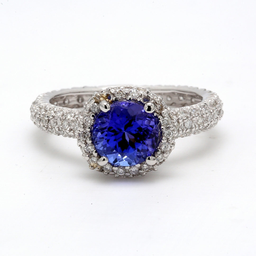 Halo eternity ring in platinum with pave set round diamonds & 4-prong set round shape tanzanite center.  D0.84ct.t.w.  Tanzanite 1.76ct.