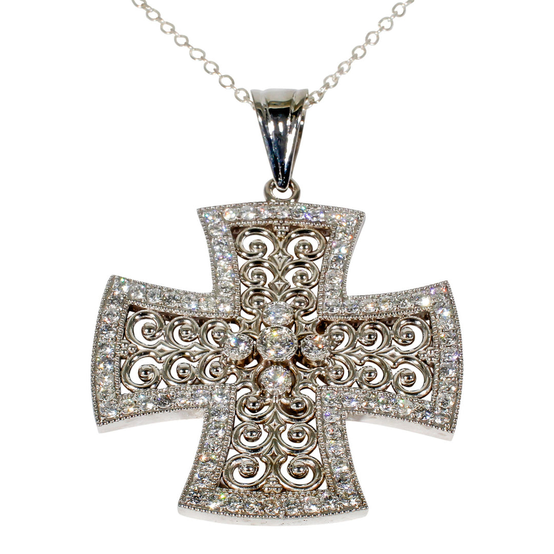 Designer cross pendant with bezel and pave set round diamonds.  D1.02ct.t.w.