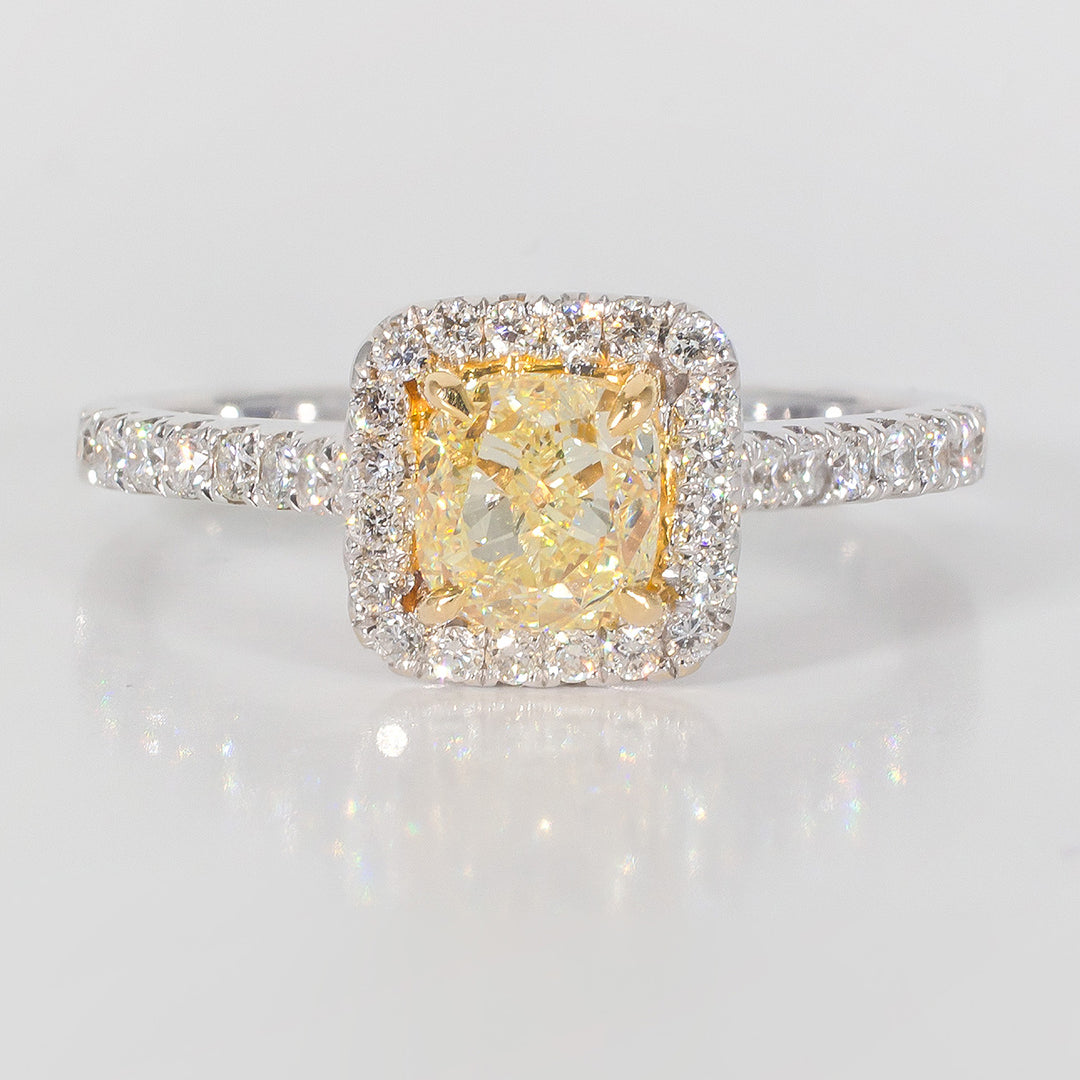 Halo ring in 18K WG with prong set rounds around 4-prong set FY cushion cut diamond center stone.  D1.34ct.t.w.  (Center 0.90ct.)