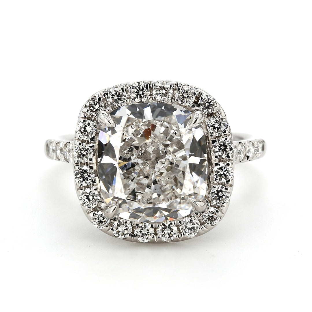 Halo ring with 4-prong  U-set rounds on each side and on gallery with GIA certified E/SI1 cushion cut diamond center.  D5.77ct.t.w.  (Center 5.03ct.)