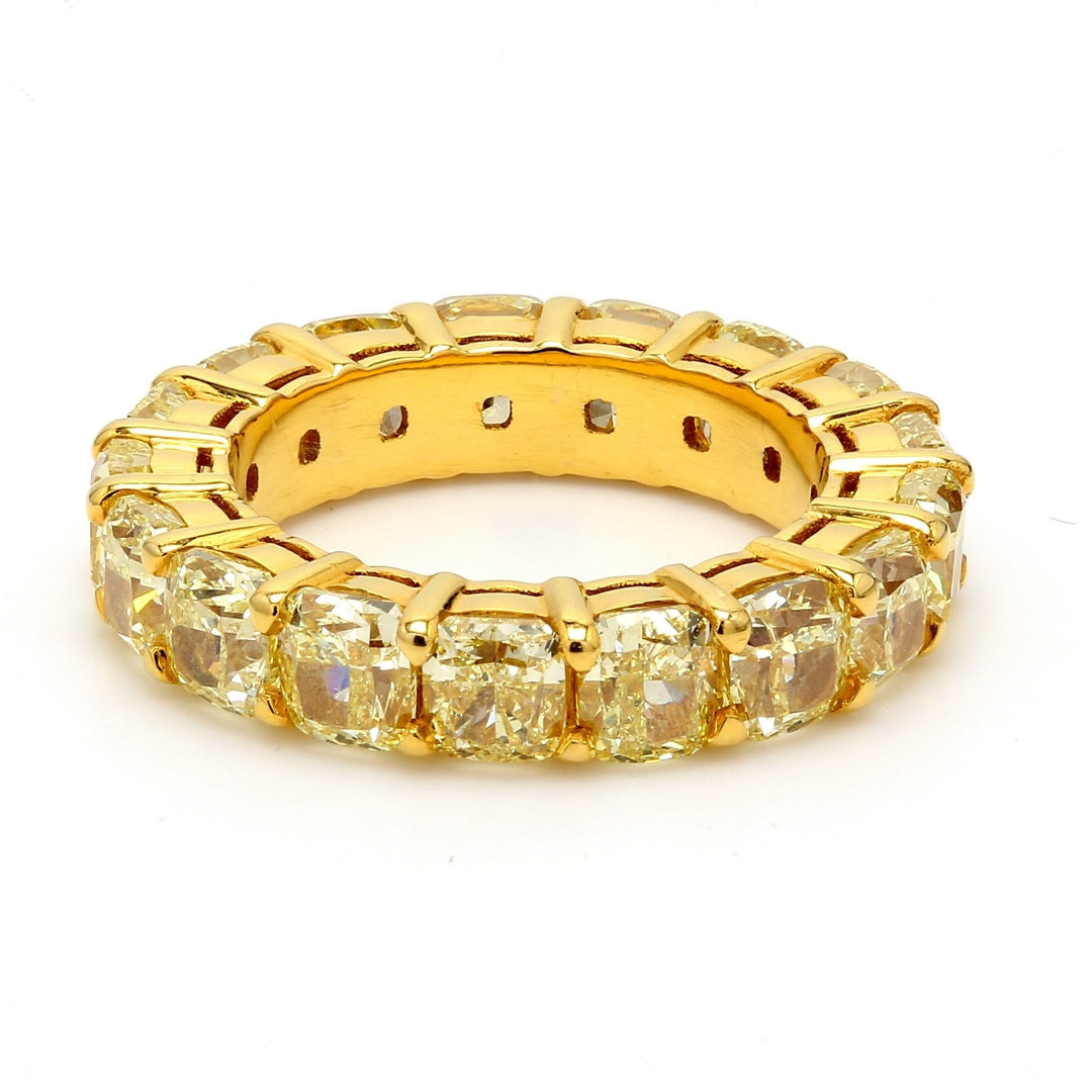 Eternity band in 18K YG with shared prong set (17) fancy yellow cushion cut diamonds.  D6.89ct.t.w.  Size 4.75