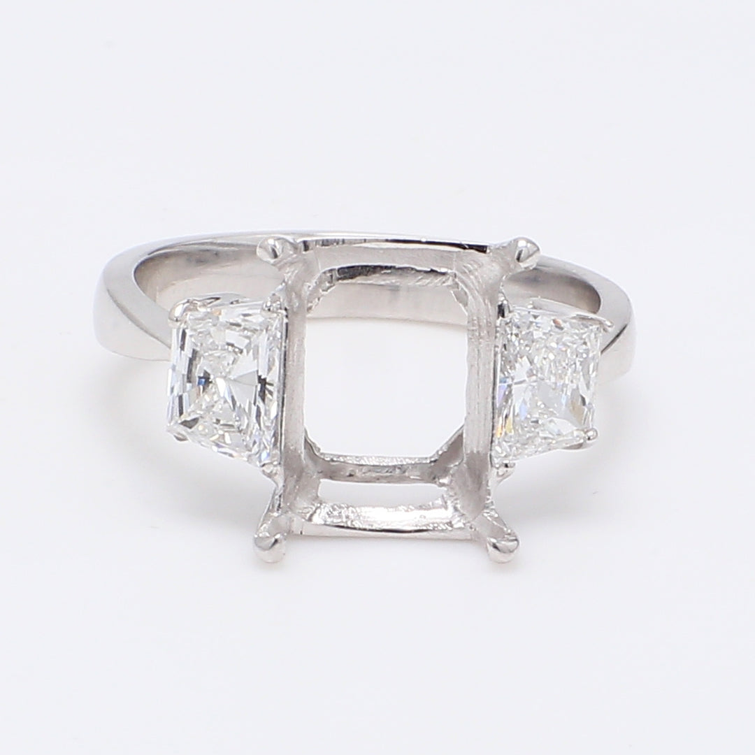 3-stone semi-mount in 18K WG with 4-prong set trapezoid diamond sides.  D0.87ct.t.w.