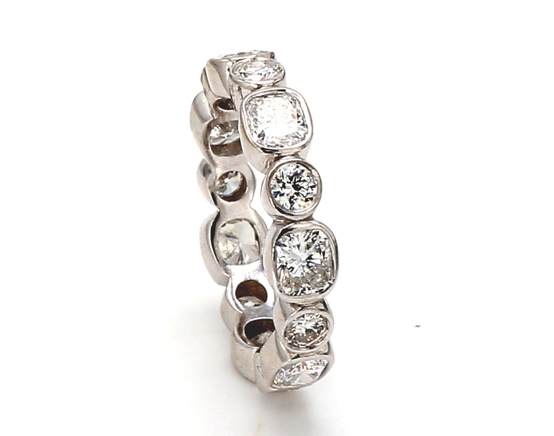 Eternity band with alternating bezel set (14) round and radiant cut diamonds.  D2.72ct.t.w.  Size 6