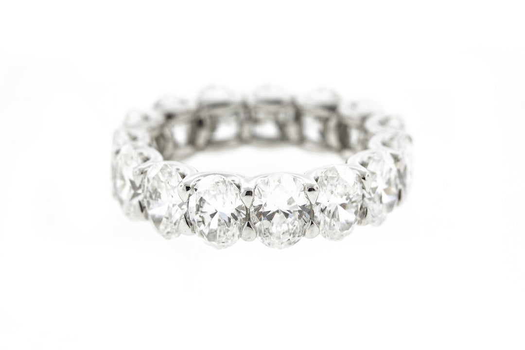 Eternity band in platinum with shared prong set GIA certified E-G/SI1-SI2 (15) oval diamonds .  D7.56ct.t.w.  Size 6.5