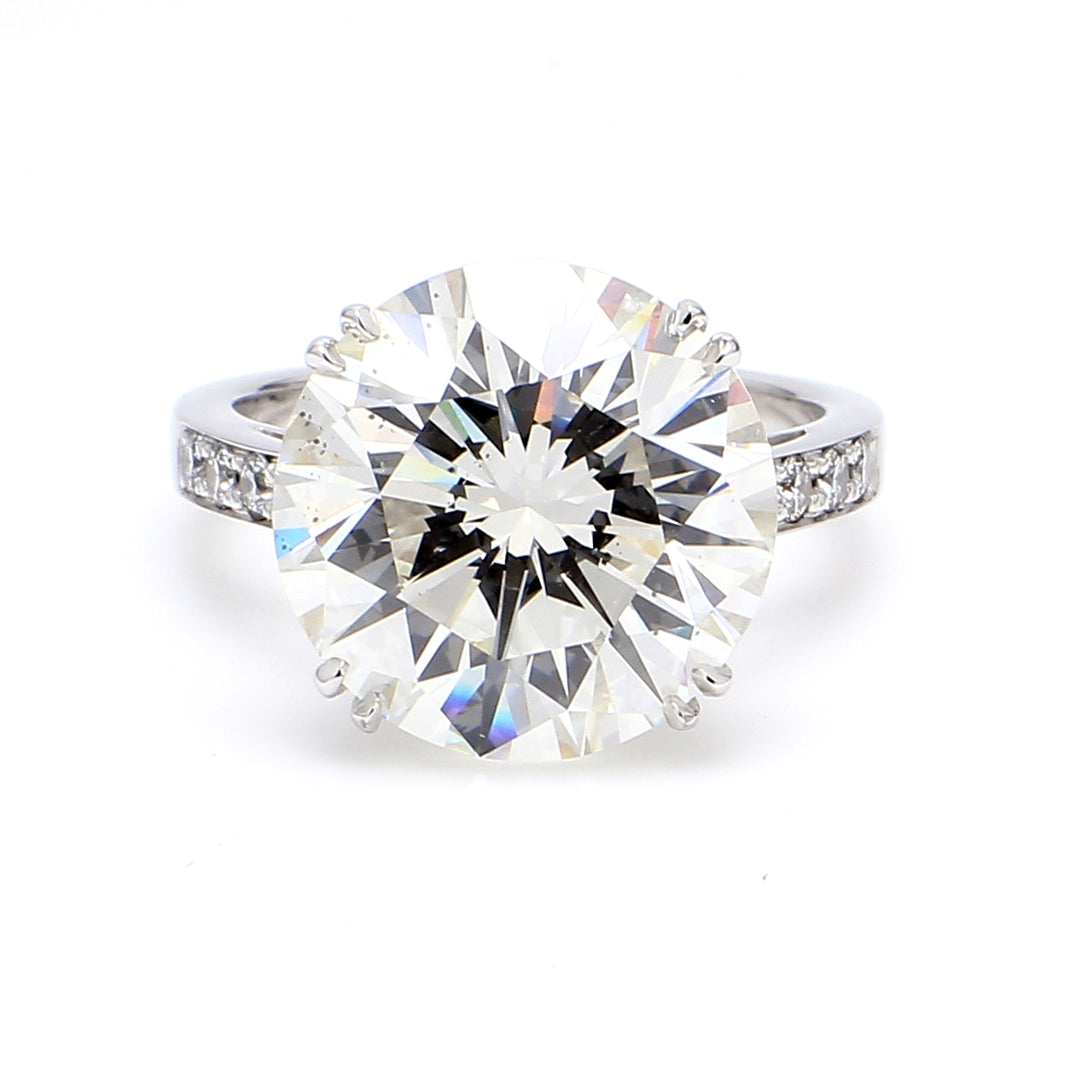 Ring in 18K WG with double prong set GIA certified E/SI2 round center and pre-set round diamonds on the sides.  D7.26ct.t.w.  (Center 7.01ct.)