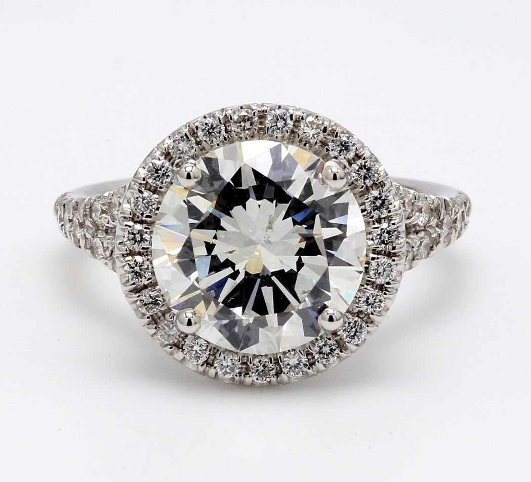 Halo split shank semi-mount in 18K WG with prong set round diamonds.  D0.58ct.t.w.