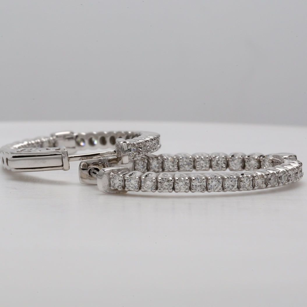 1"" Oval shaped inside out hoop earrings with 4-prong set round diamonds.  D1.28ct.t.w.