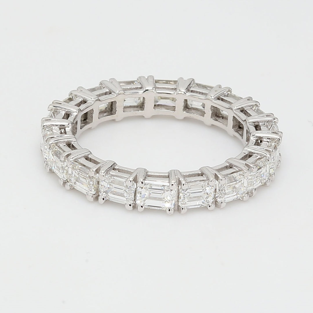 East to west style eternity band in platinum with prong set emerald cut diamonds.  D2.63ct.t.w.  Size 5