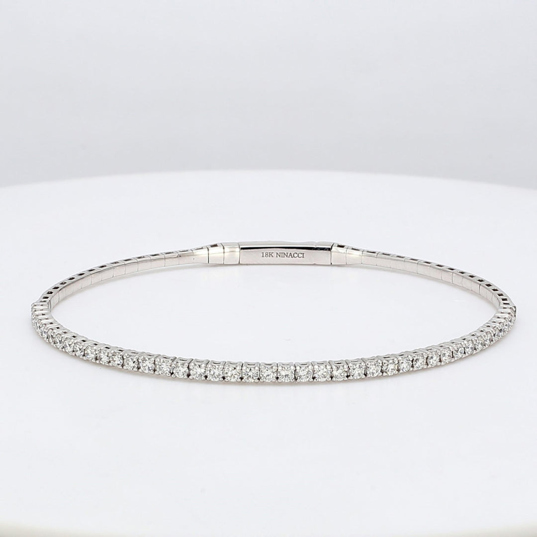 6.25"" Lightweight flexible bangle in 18K WG with 4-prong set round diamonds.  D1.02ct.t.w.