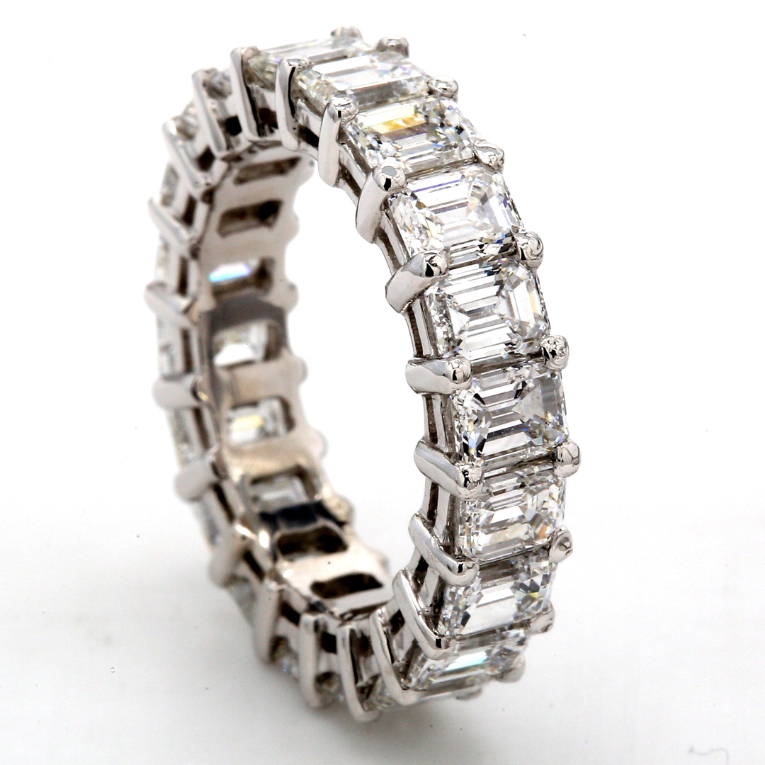 Eternity band in platinum with shared prong set emerald cut diamonds.  D6.14ct.t.w.