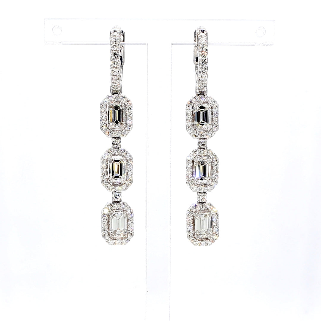 Halo dangling earrings with 4-prong set emerald cuts & round diamonds.  D2.89ct.t.w.