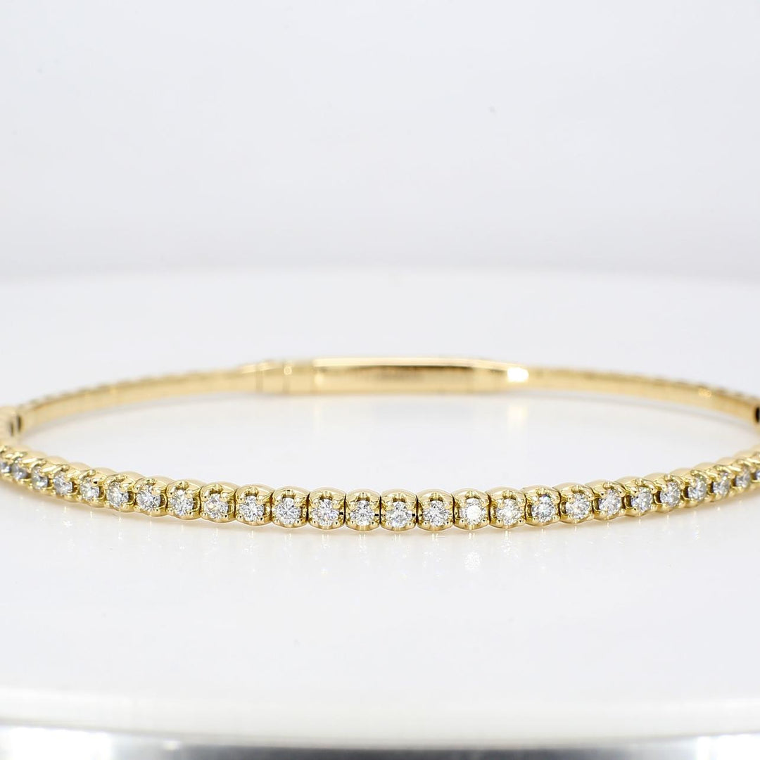 6.5"" Lightweight flexible oval shaped bangle in 18K YG with prong set round diamonds.  D0.88ct.t.w.