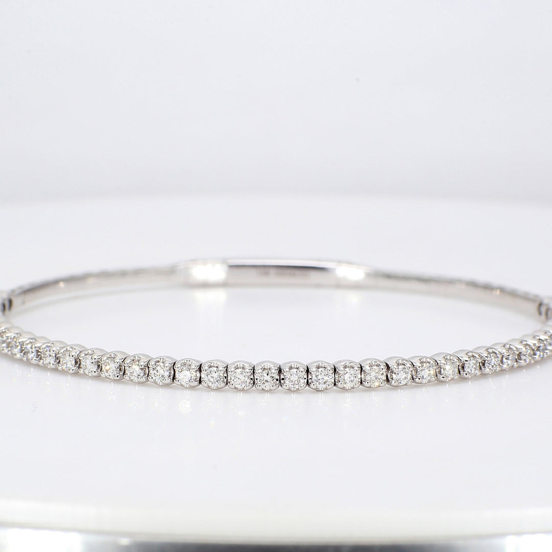 6.25"" Lightweight flexible oval shaped bangle in 18K WG with prong set round diamonds.  D0.88ct.t.w.