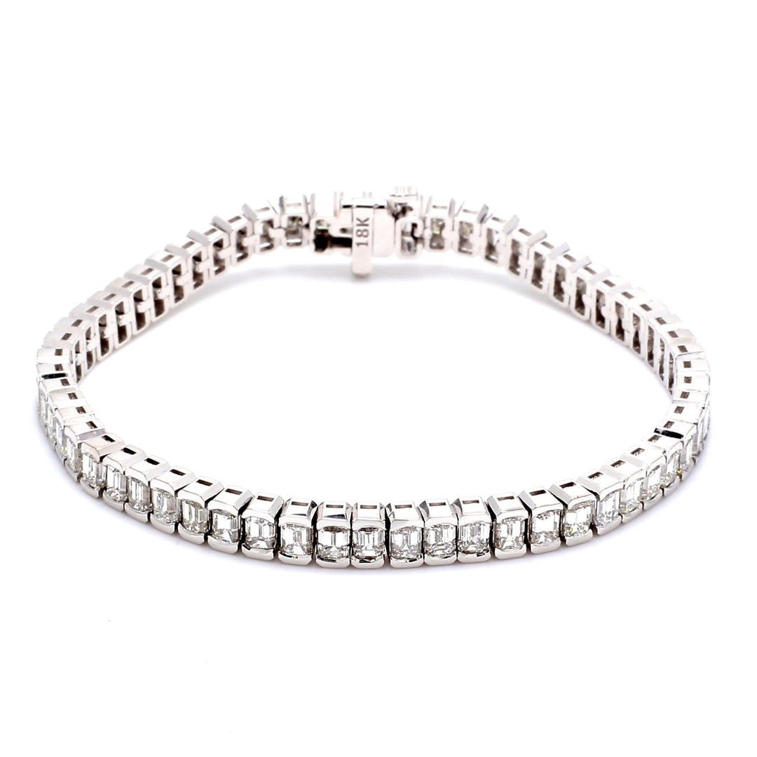 7"" Tennis bracelet in 18K WG with half bezel set (60) emerald cut diamonds.  D11.12ct.t.w.