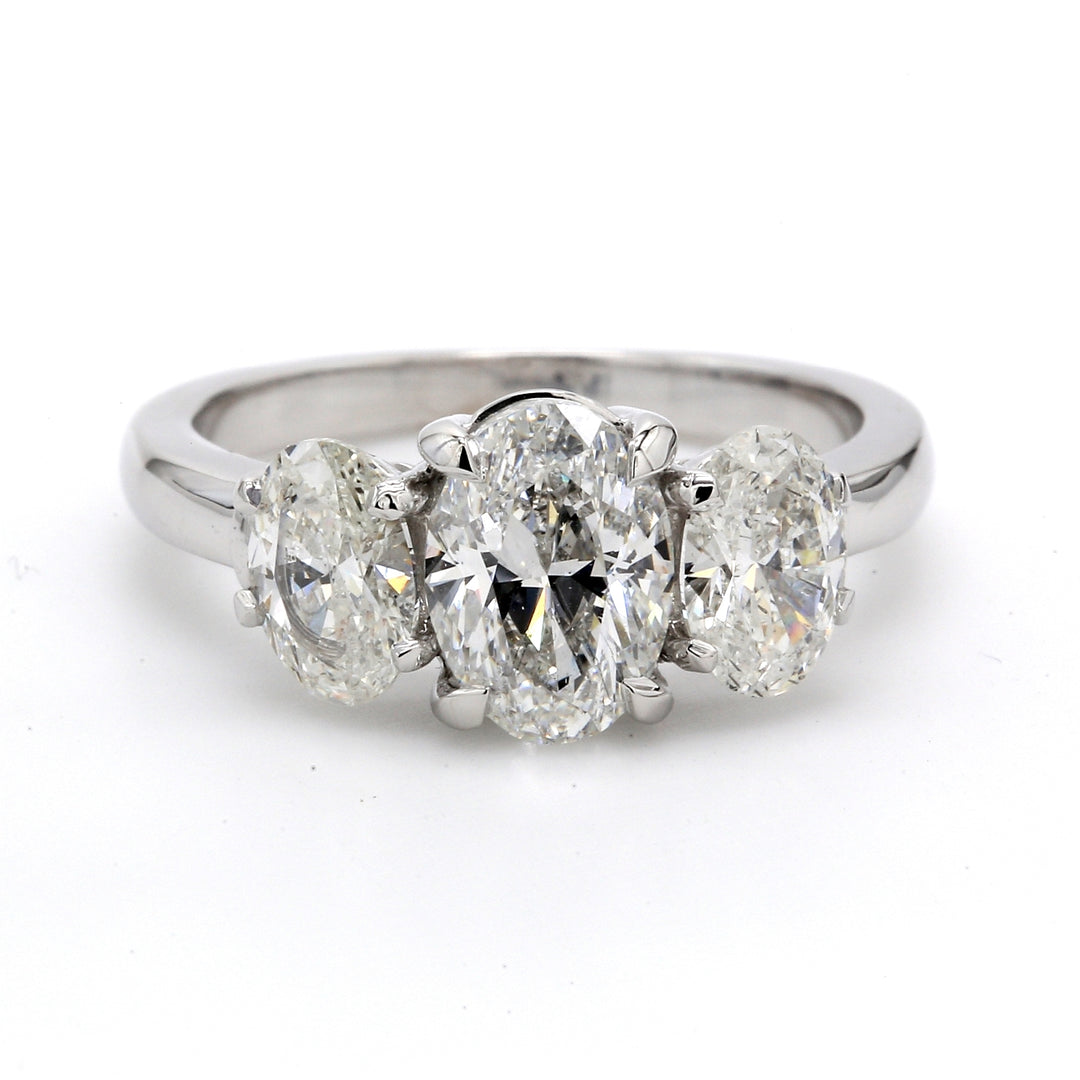 3-stone semi-mount with oval diamond sides.  D1.21ct.t.w.