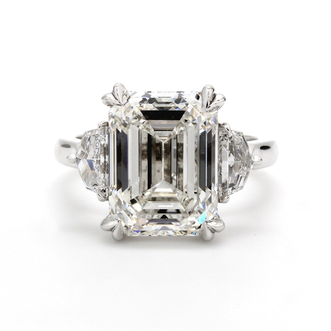 3-stone ring in platinum with claw prong set GIA certified H/VS1 emerald cut center and 3-prong set  H/VS1 shield diamond sides.  D8.78ct.t.w.  (Center 8.01ct.)