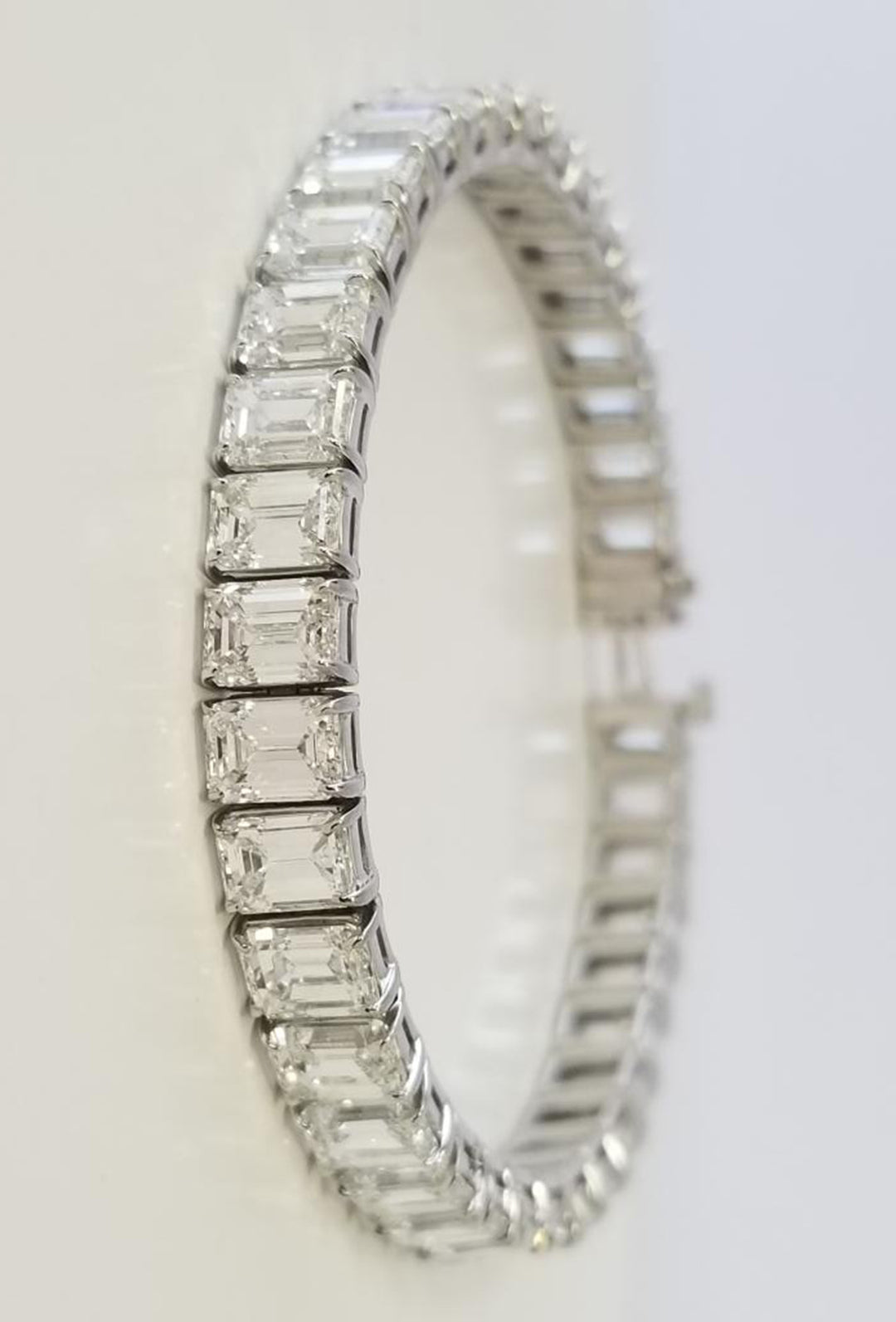 7"" Tennis bracelet in platinum with basket prong set GIA certified G-I/VVS1-VS2 (43) emerald cut diamonds.  D21.83ct.t.w.