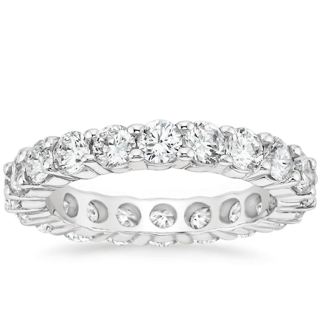 Eternity band in platinum with shared prong set G/VS-SI round diamonds.  D3.90ct.t.w.