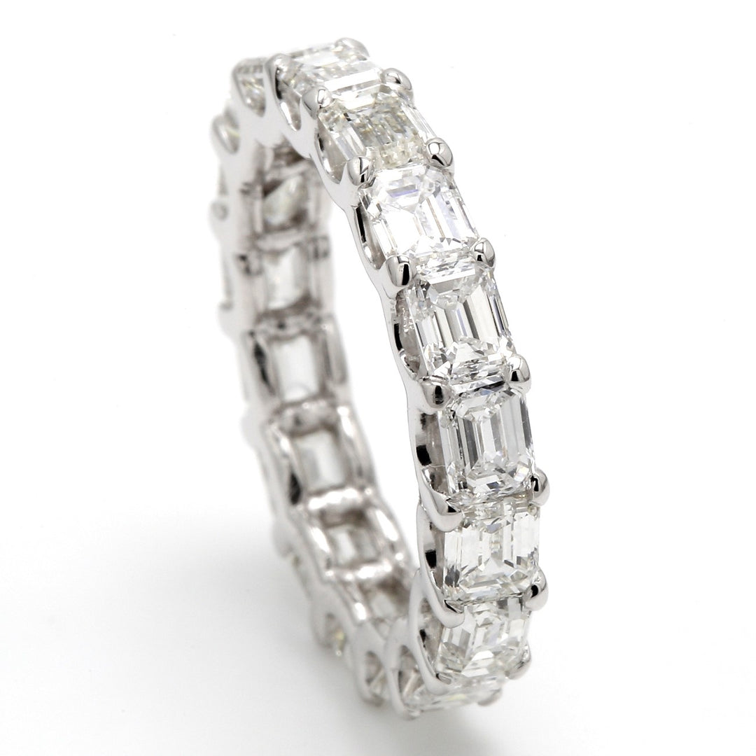 East to west style eternity band with U-prong set (17) emerald cut diamonds.  D4.05ct.t.w.