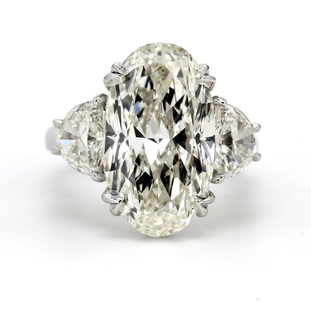 3-stone semi-mount in platinum with prong set half moon diamond sides.  D1.61ct.t.w.