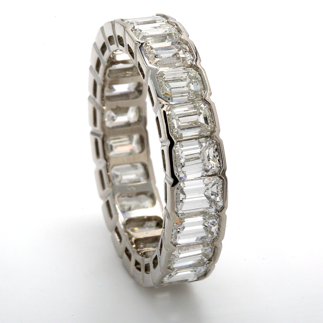 Eternity band in platinum with channel set (24) emerald cut diamonds.  D4.52ct.t.w.  Size 6.25