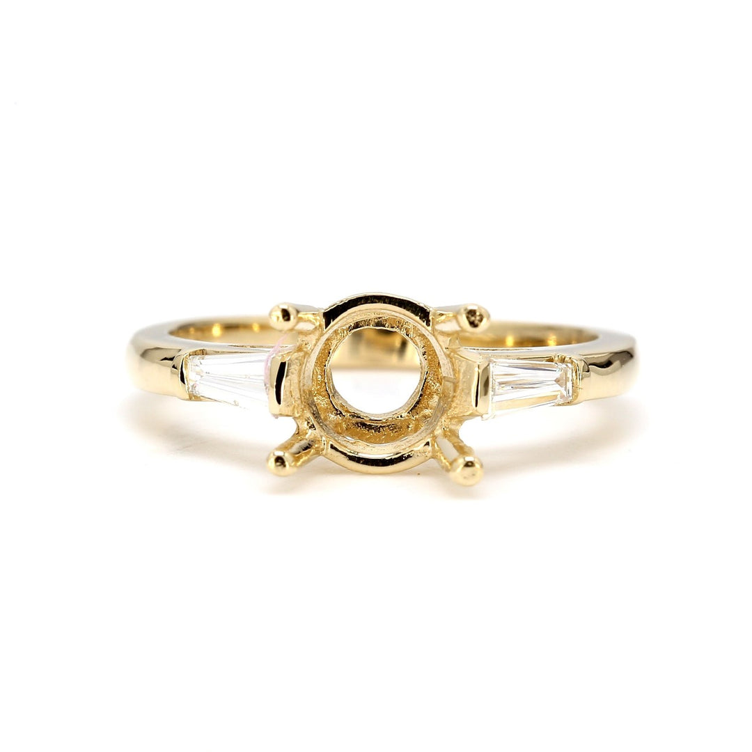 3-stone semi-mount in yellow gold with channel set tapered baguette diamond sides.  D0.24ct.t.w.