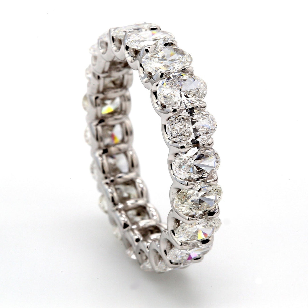 Eternity band in platinum with shared U-prong set (21) oval cut diamonds.  D3.86ct.t.w.  Size 6.75