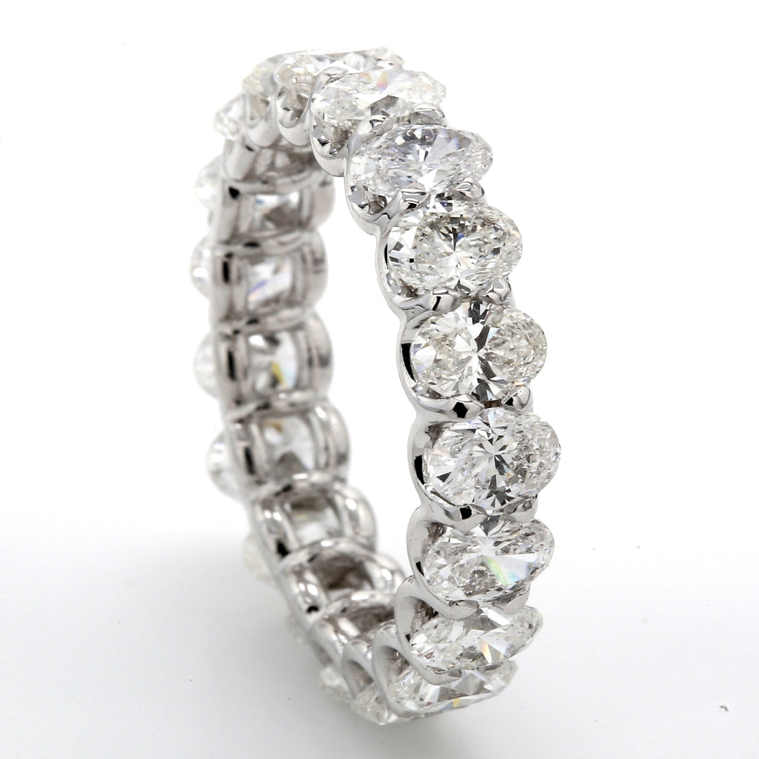 Eternity band in platinum with shared 4-prong set (19) oval cut diamonds.  D4.32ct.t.w.  Size 6