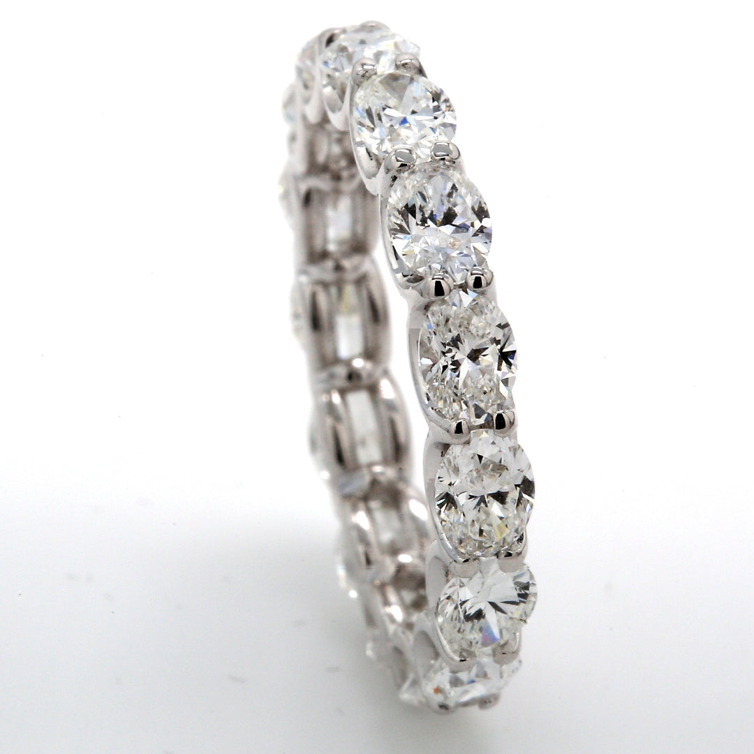 East to west style eternity band with shared U-prong set G-H/VS (15) oval cut diamonds.  D3.49ct.t.w.  Size 7