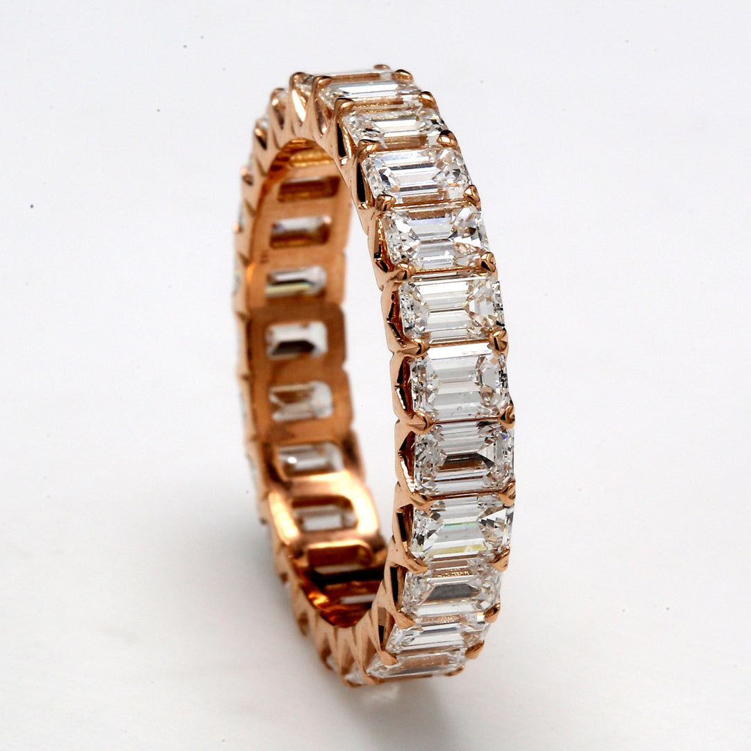 Eternity band in 18K RG with U-prong set (25) emerald cut diamonds.  D3.49ct.t.w.  Size 6.5