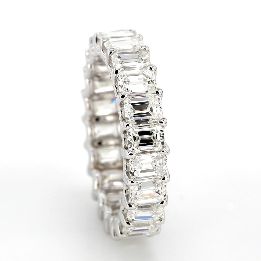 Eternity band in 18K WG with shared U-prong set (22) emerald cut diamonds.  D4.19ct.t.w.  Size 5.25