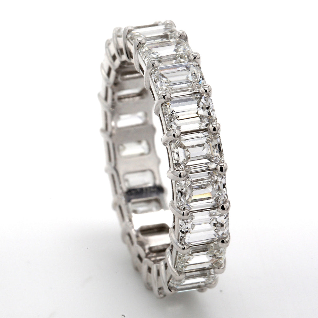 Eternity band in platinum with basket claw set (21) emerald cut diamonds.  D5.13ct.t.w.  Size 6.5