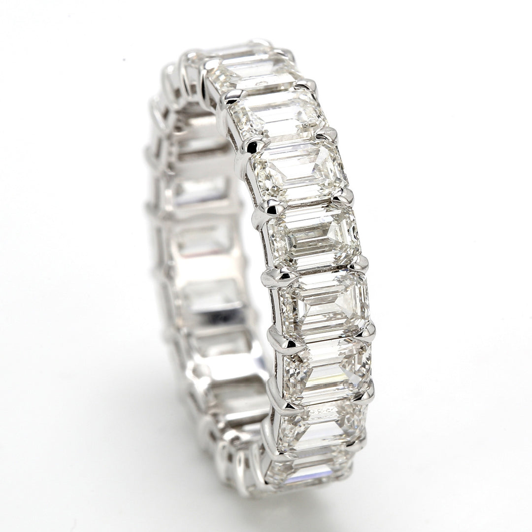 Eternity band in platinum with shared prong set emerald cut diamonds.  D6.48ct.t.w.  Size 7.25