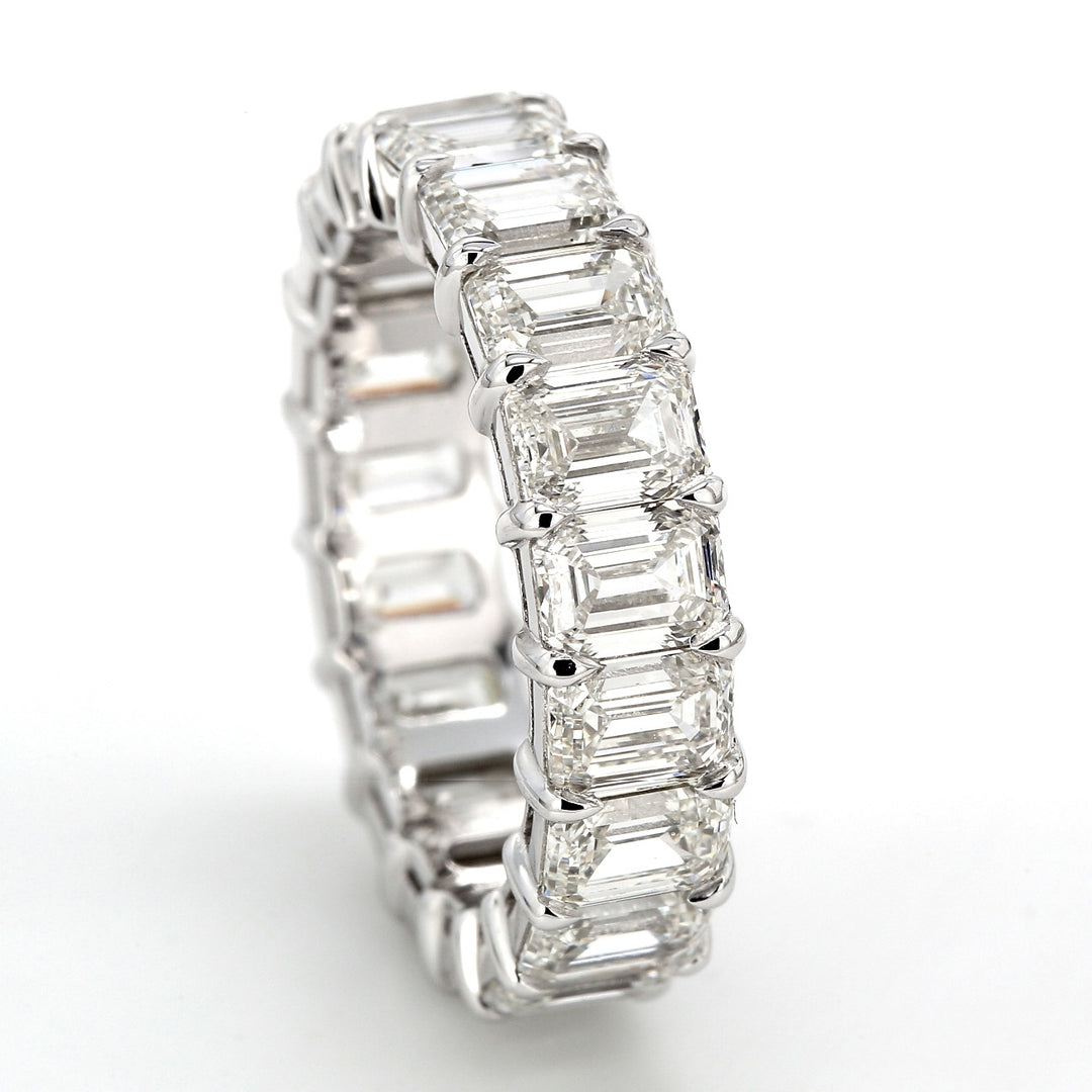 Eternity band in platinum with shared claw prong basket set (19) emerald cut diamonds.  D5.73ct.t.w.  Size 5.5