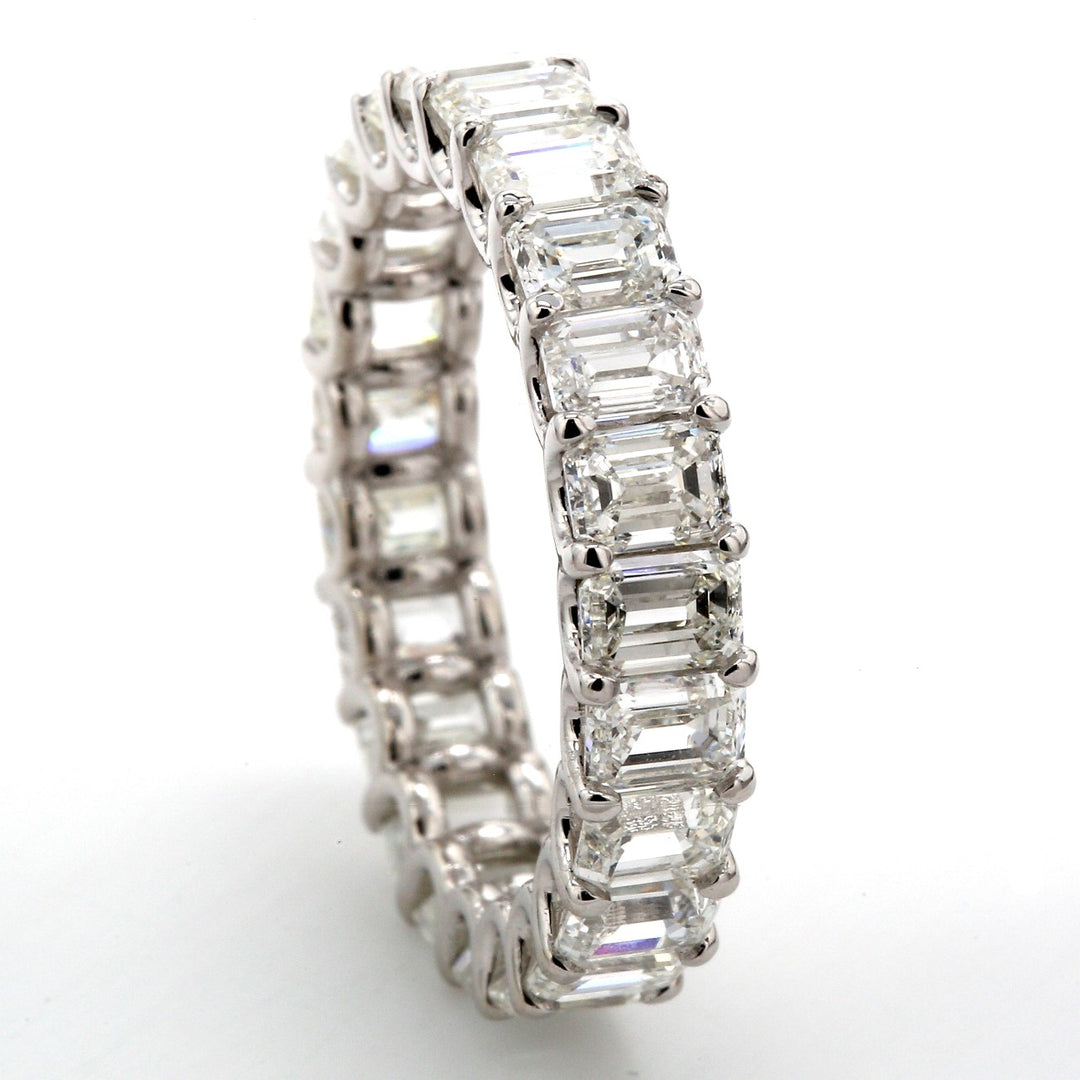 Eternity band in platinum with shared U-prong set emerald cut diamonds.  D4.14ct.t.w.