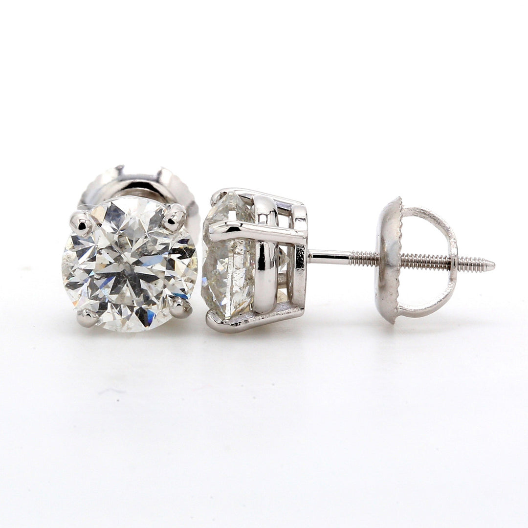 Screw back stud earrings with 4-prong basket set USA certified J-K/SI1 round diamonds.  D4.01ct.t.w.