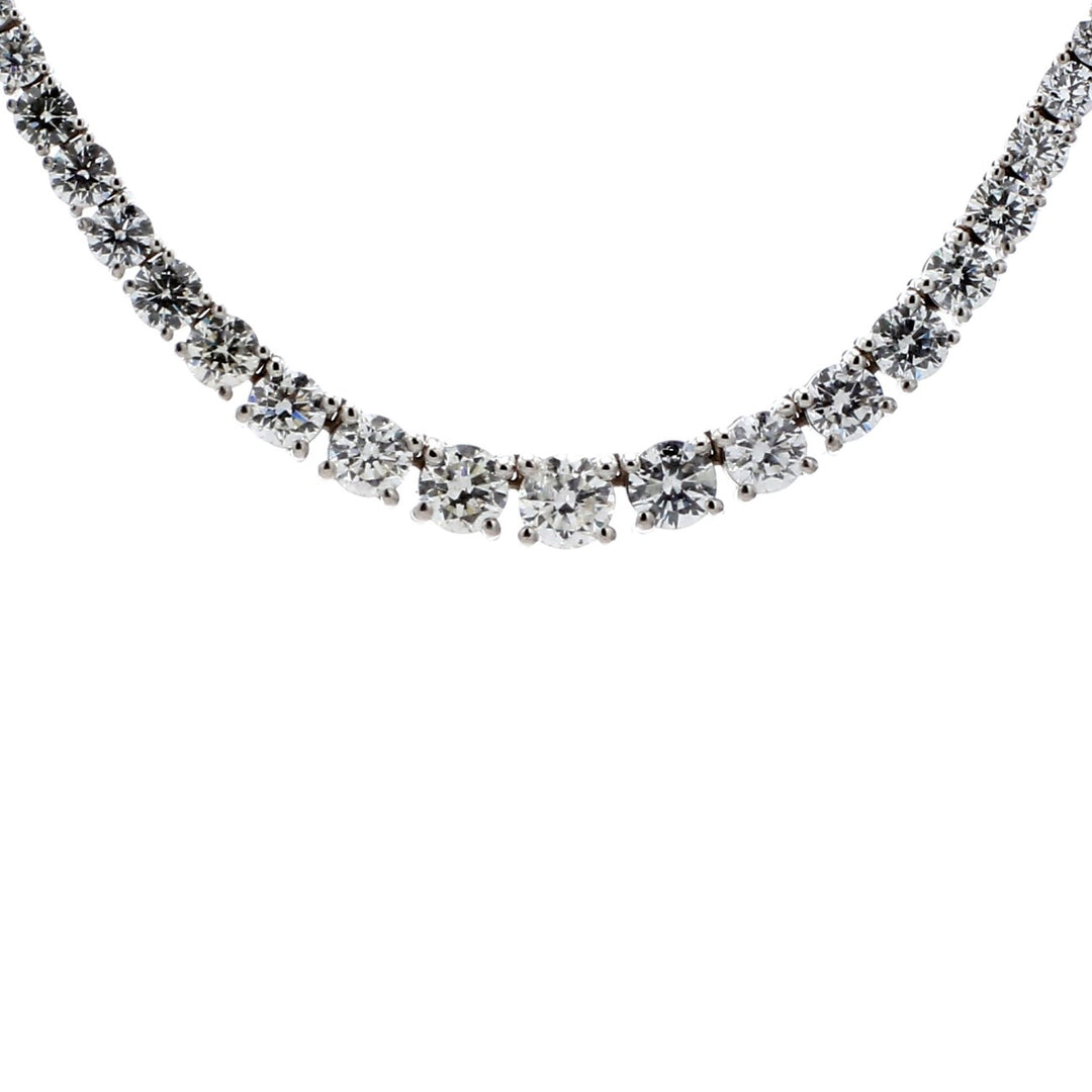 16"" Graduated half-way tennis necklace in white gold w/ 4-prong set (83) round diamonds. D6.06ct.t.w.