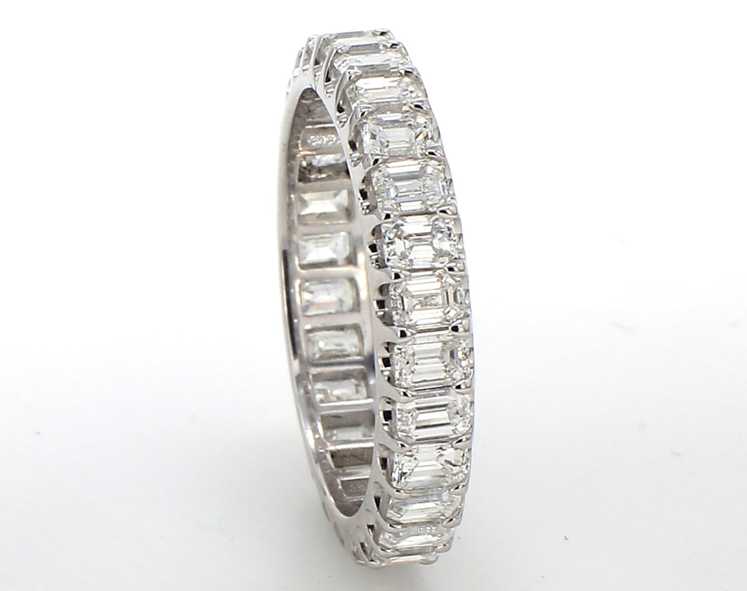 Eternity band in platinum with U-prong set (28) emerald cut diamonds.  D2.81ct.t.w.  Size 6.5