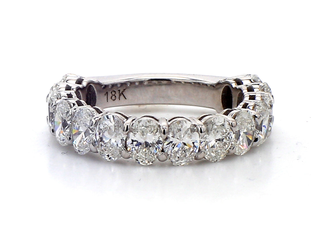 3/4 way band in 18K WG with basket prong set (14) oval cut diamonds.  D2.60ct.t.w.  Size 4.75