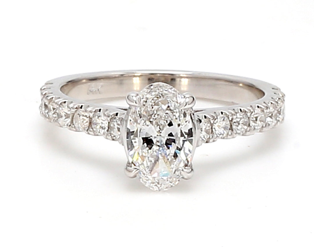 Ring with single row rounds on shank and prong set GIA certified E/SI2 oval diamond center.  D1.36ct.t.w.  (Center - 0.90ct.)