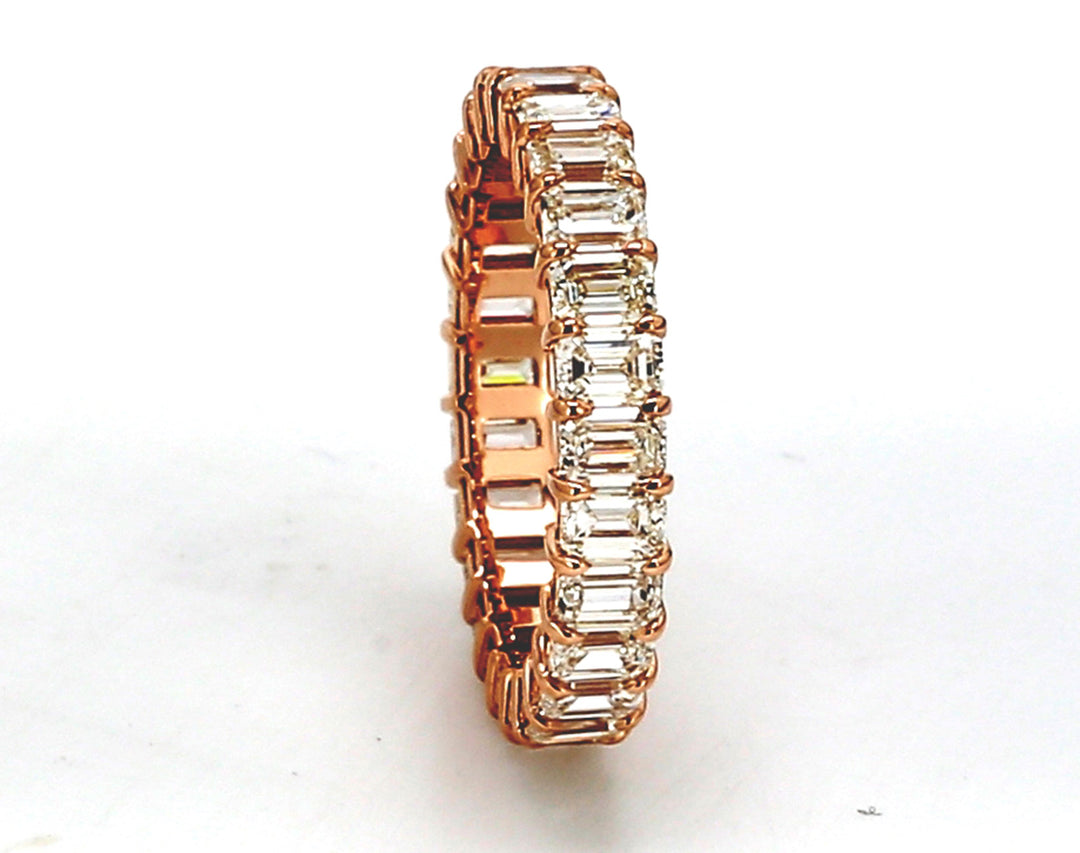 Eternity band in 18K RG with basket prong set (26) emerald cut diamonds.  D2.85ct.t.w.  Size 5.25